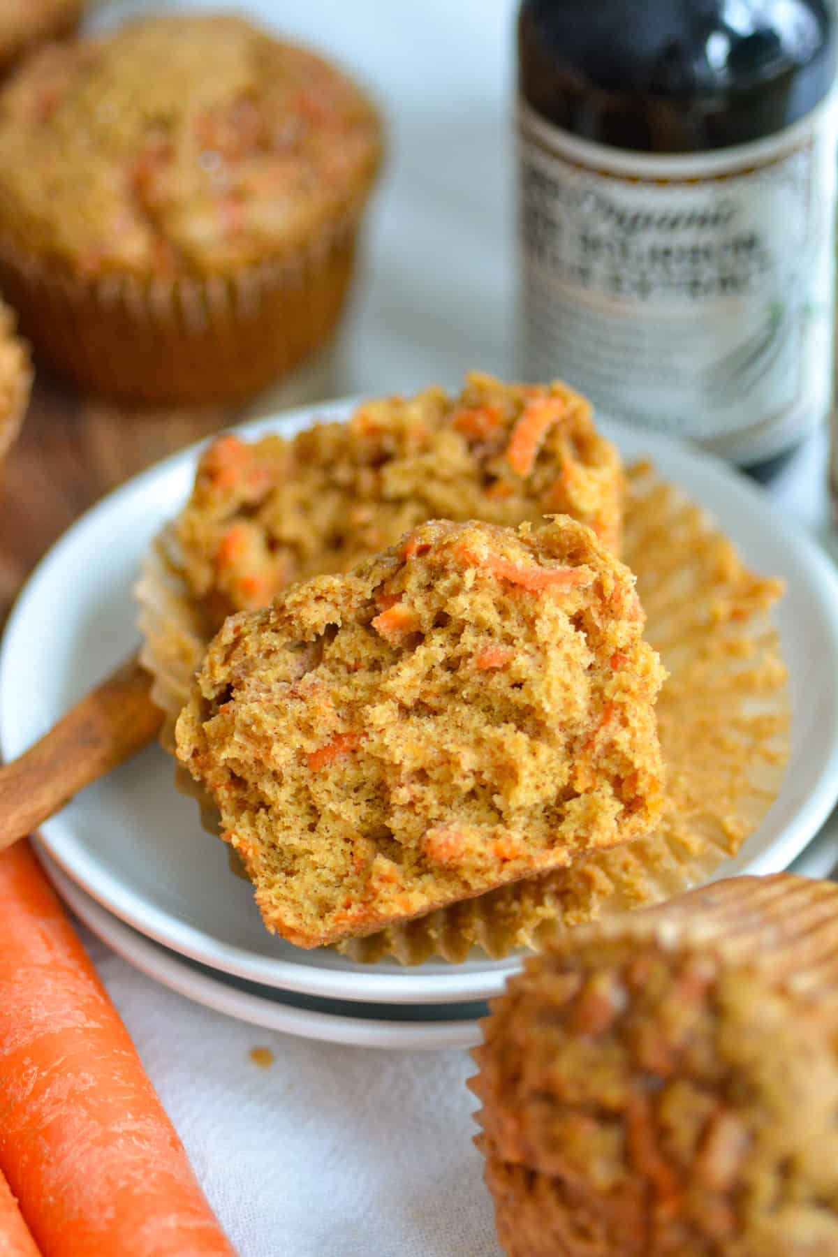 Vegan Carrot Muffin that is broken in half on a small plate.