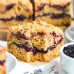 A slice of Cherry Crumb Cake with a bite taken out of it.
