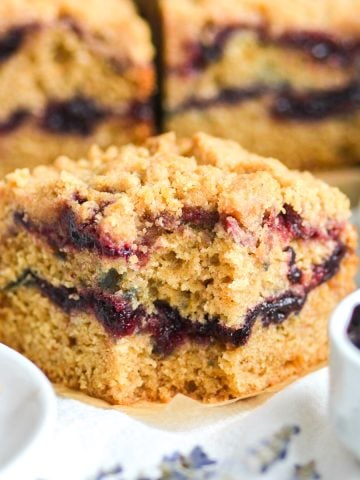 A slice of Cherry Crumb Cake with a bite taken out of it.