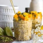 Mango Overnight Oats in a jar topped with fresh mango chunks.
