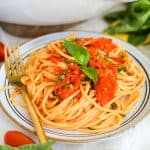 A plate with spaghetti with Roasted Cherry Tomato Sauce on top.