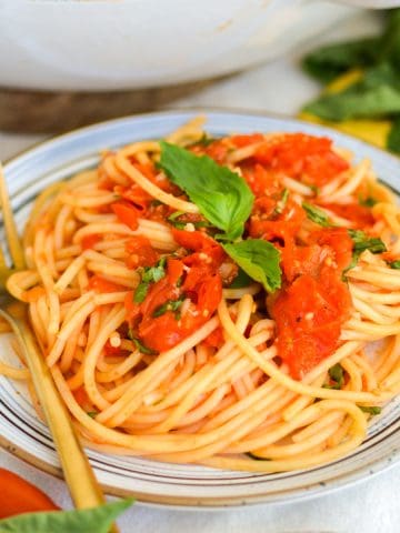 A plate with spaghetti with Roasted Cherry Tomato Sauce on top.