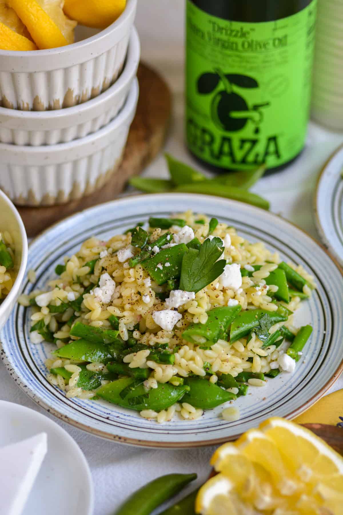 Vegan Lemon Orzo Pasta Salad on a small plate on a linen cloth.
