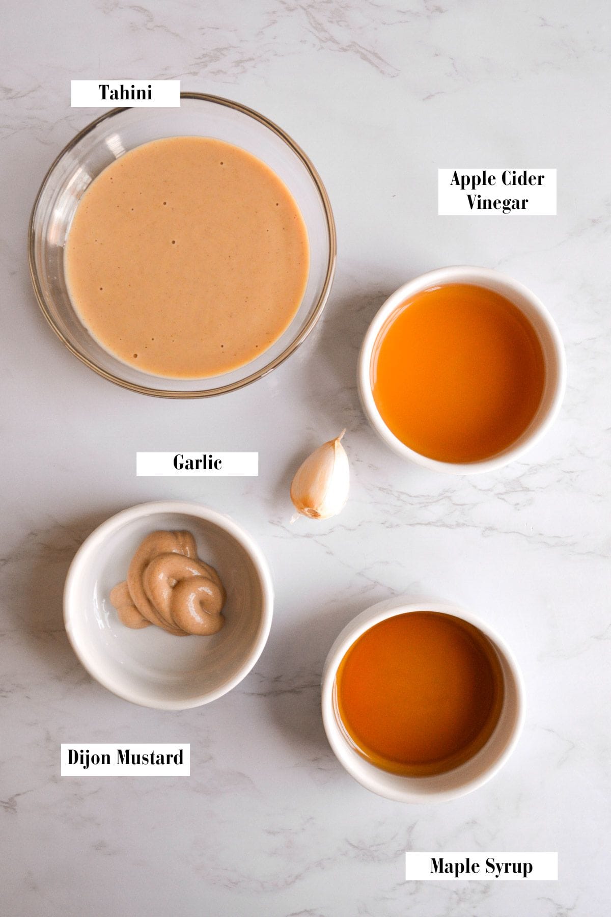 Ingredients for this recipe in small bowls on a marble surface.