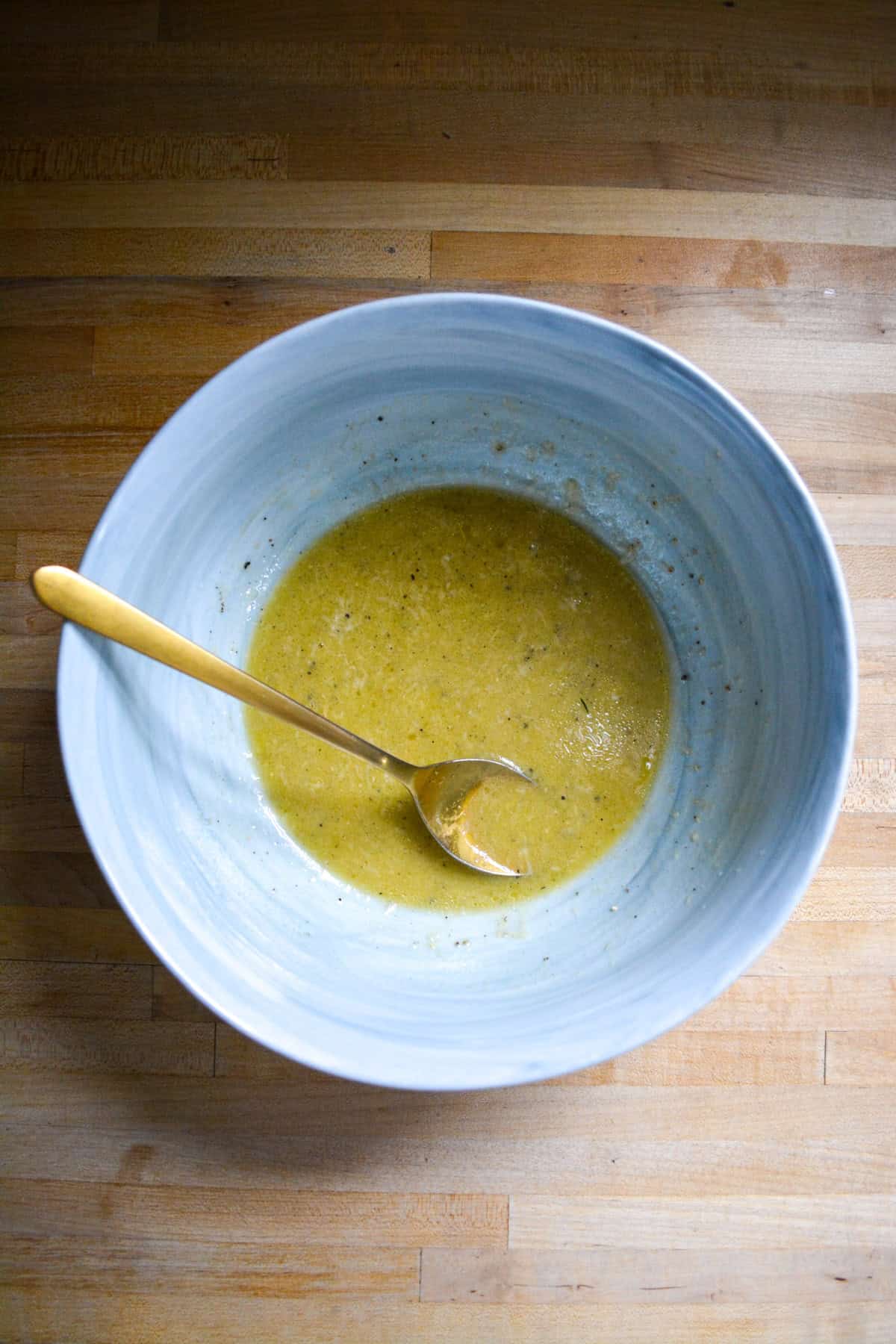 Lemon vinaigrette in a large mixing bowl.