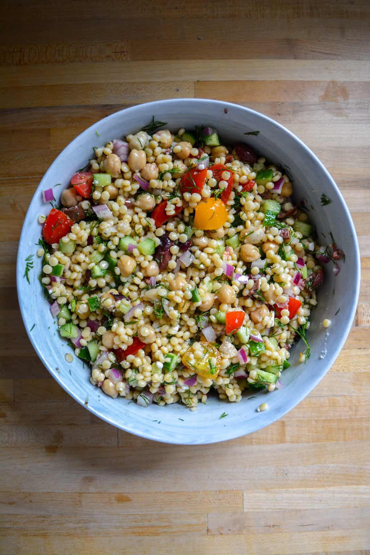 Mediterranean couscous salad in a large mixing bowl.