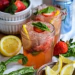 Strawberry Basil Mocktail on a lined cloth with a small bowl of lemon slices in the scene.
