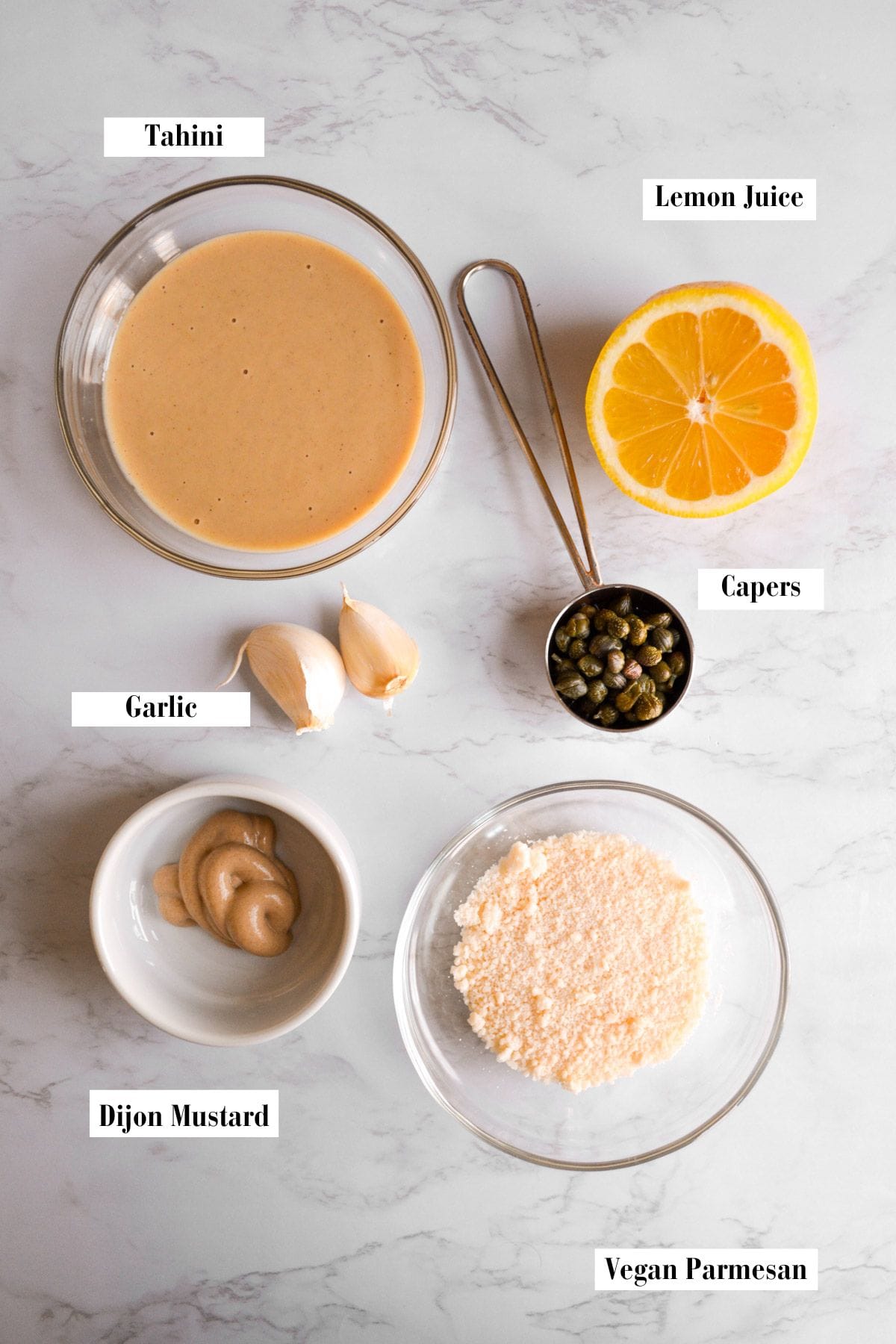 Ingredients for this recipe in small bowls on a marble surface.