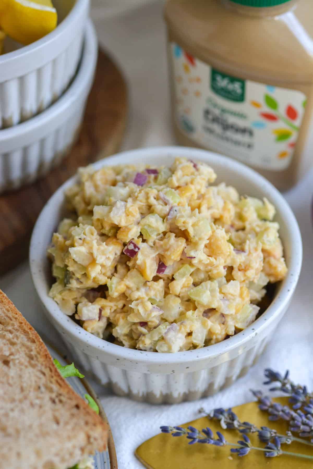 Chickpea Tuna Salad in a white ramekin on a linen cloth.