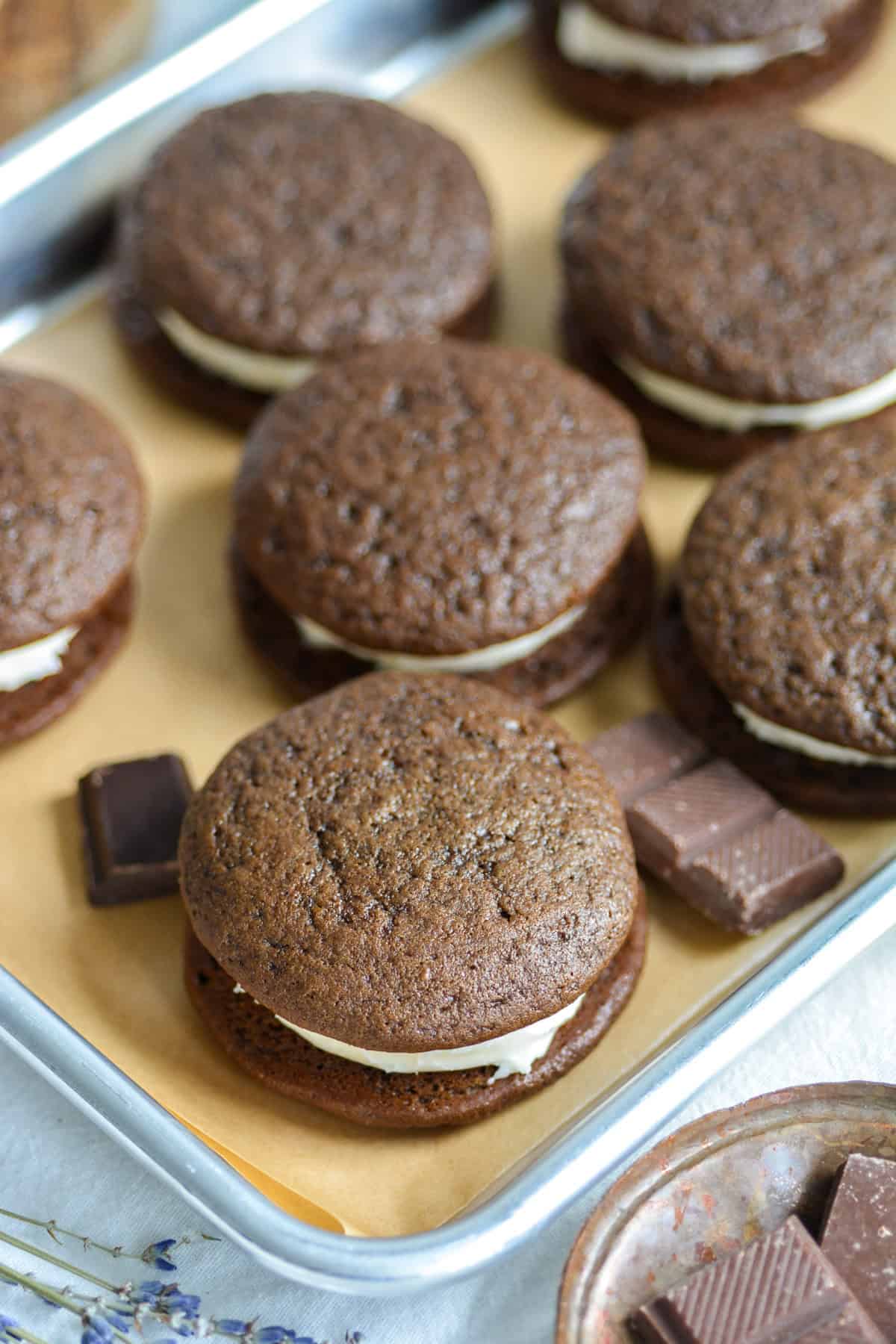 Finished Vegan Chocolate Whoopie Pies on a baking sheet.
