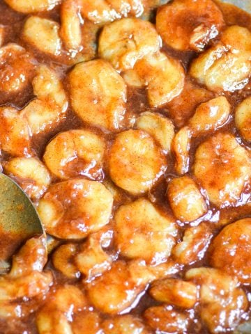 Caramelized Banana slices in a skillet.