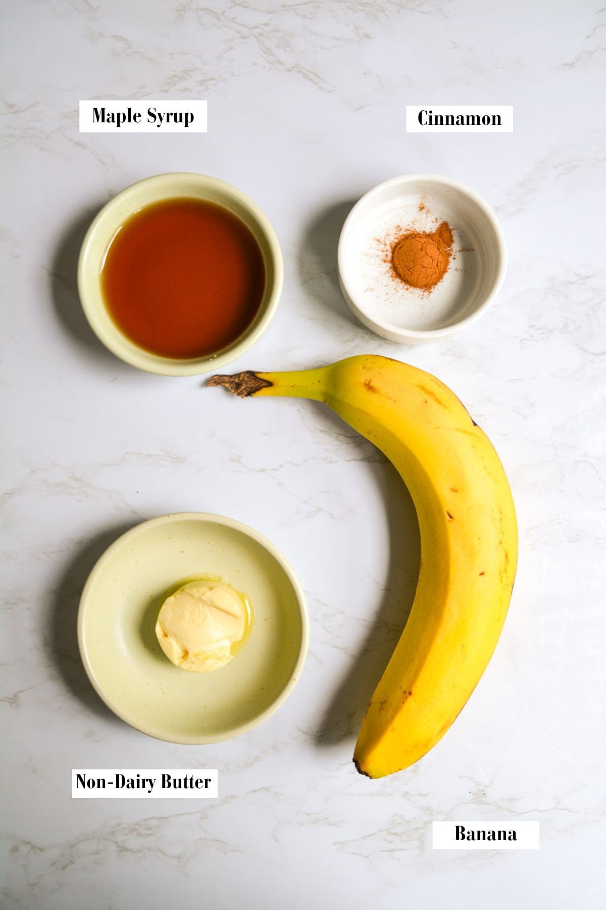 Ingredients for making this recipe in small bowls on a marble surface.