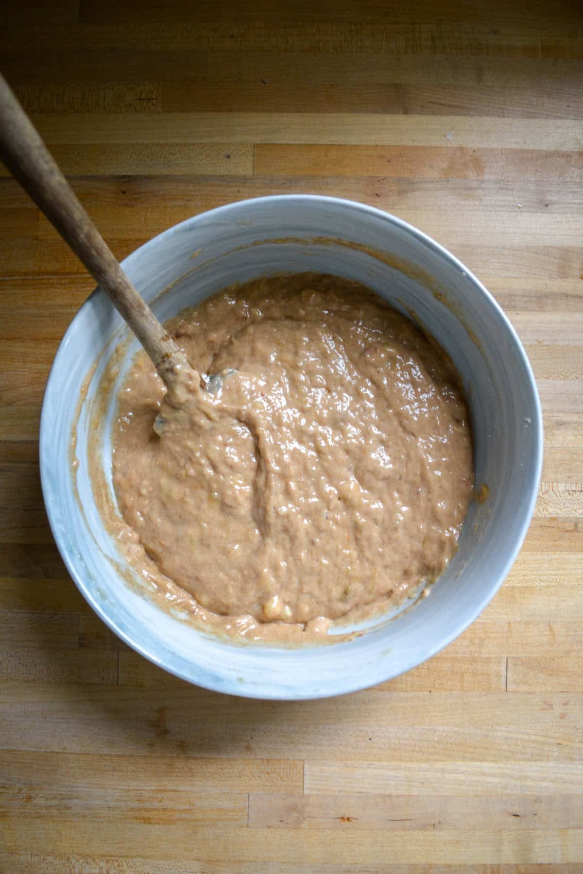 Banana bread batter in a large mixing bowl.