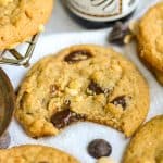 A Vegan Peanut Butter Chocolate Chip Cookie with a bite taken out of it.