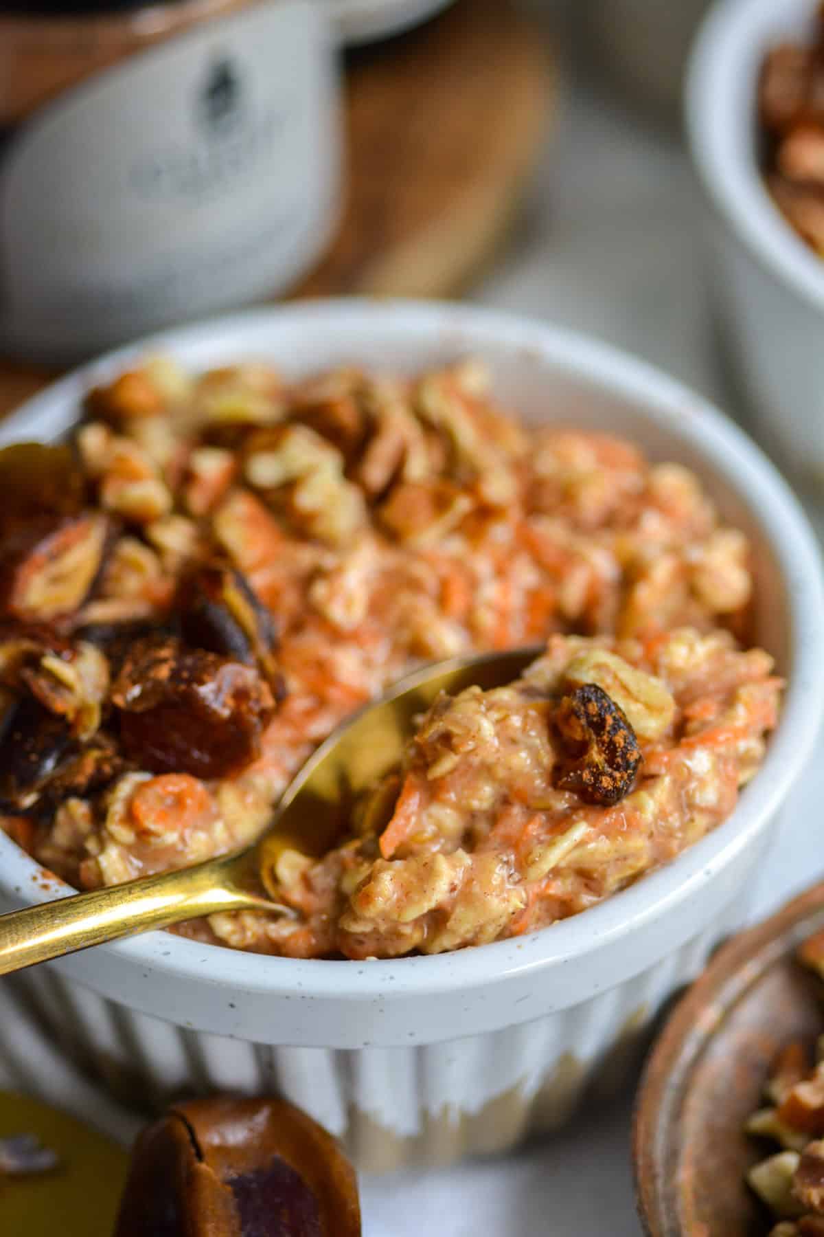A gold spoon with a bite of overnight oatmeal with no chia seeds on it.