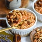 Carrot Cake Overnight Oats in a white ramekin with a gold spoon in it.