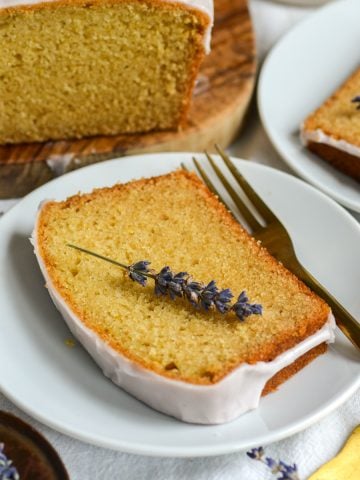 A slice of lemon lavender cake on a white plate.