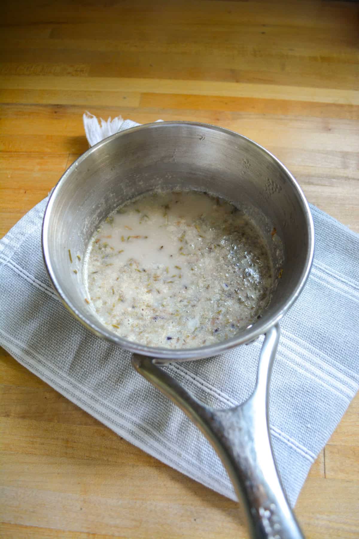 Non-dairy milk and lavender in a saucepan.