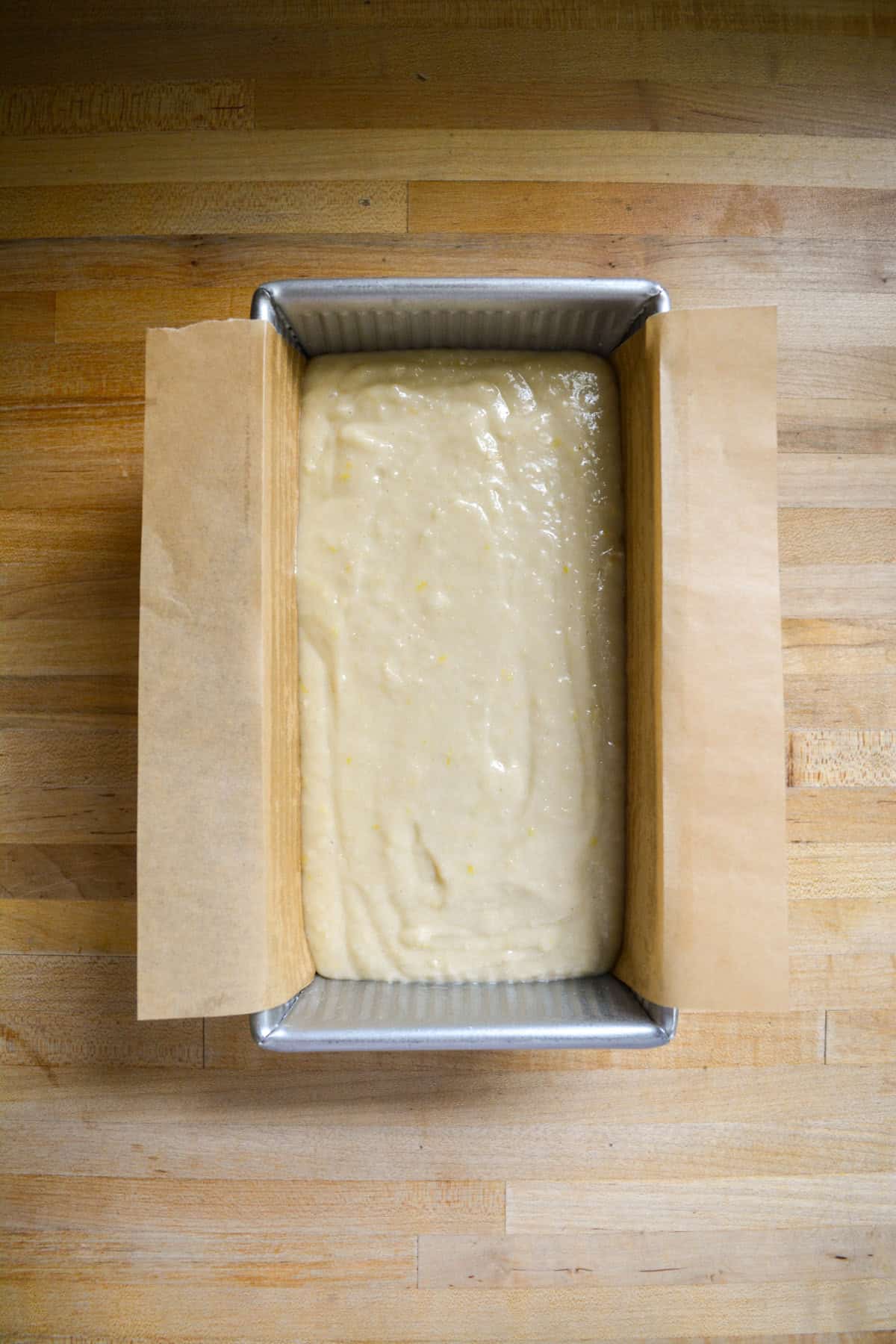 Cake batter in a prepared loaf pan.