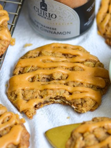 A Pumpkin Oatmeal Cookie with a bite taken out of it.