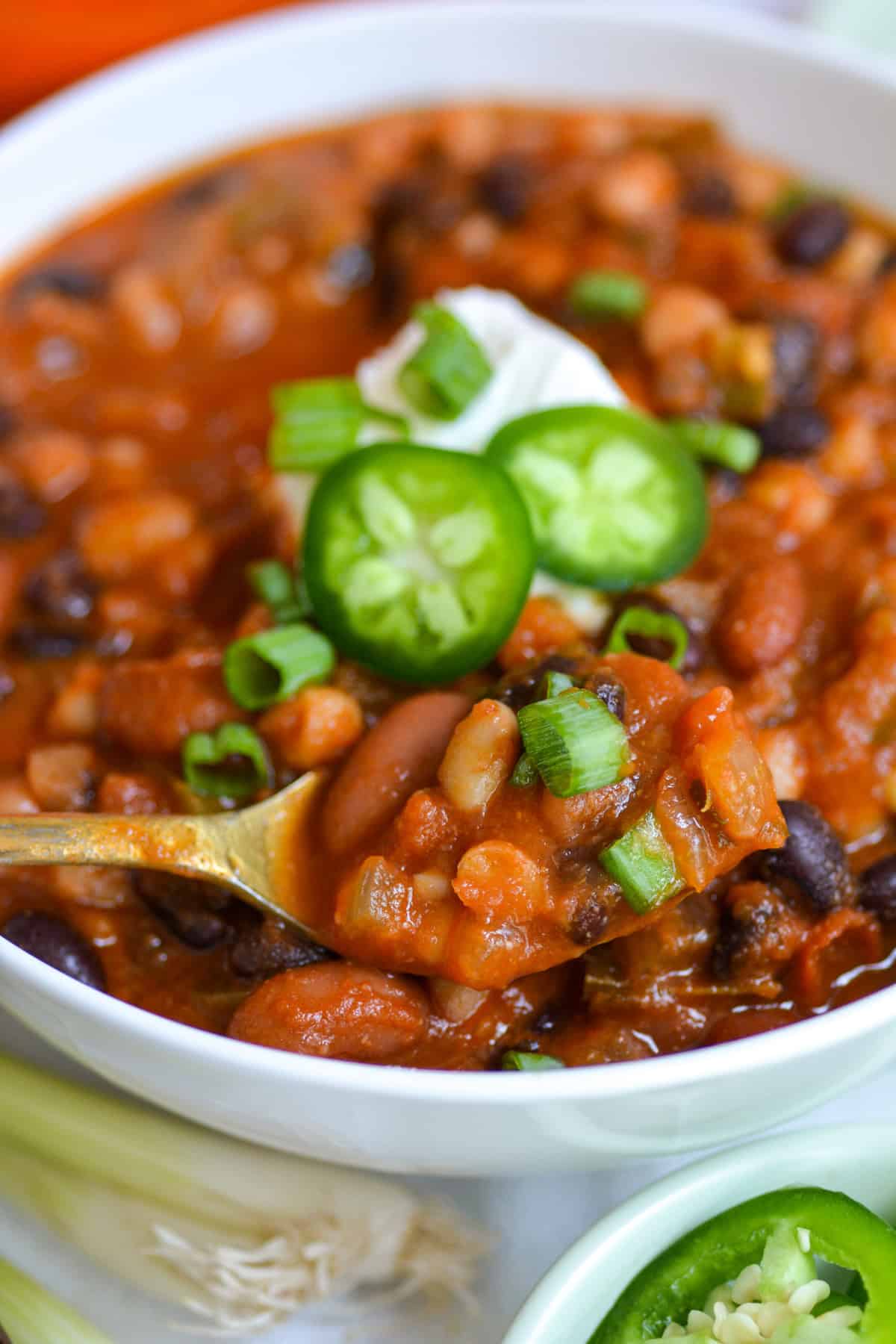 A bowl of Vegetarian Three Bean Chili with a spoon in it.