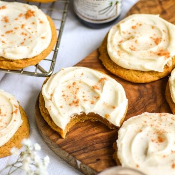 Vegan Iced Pumpkin Cookies on a wooden board.
