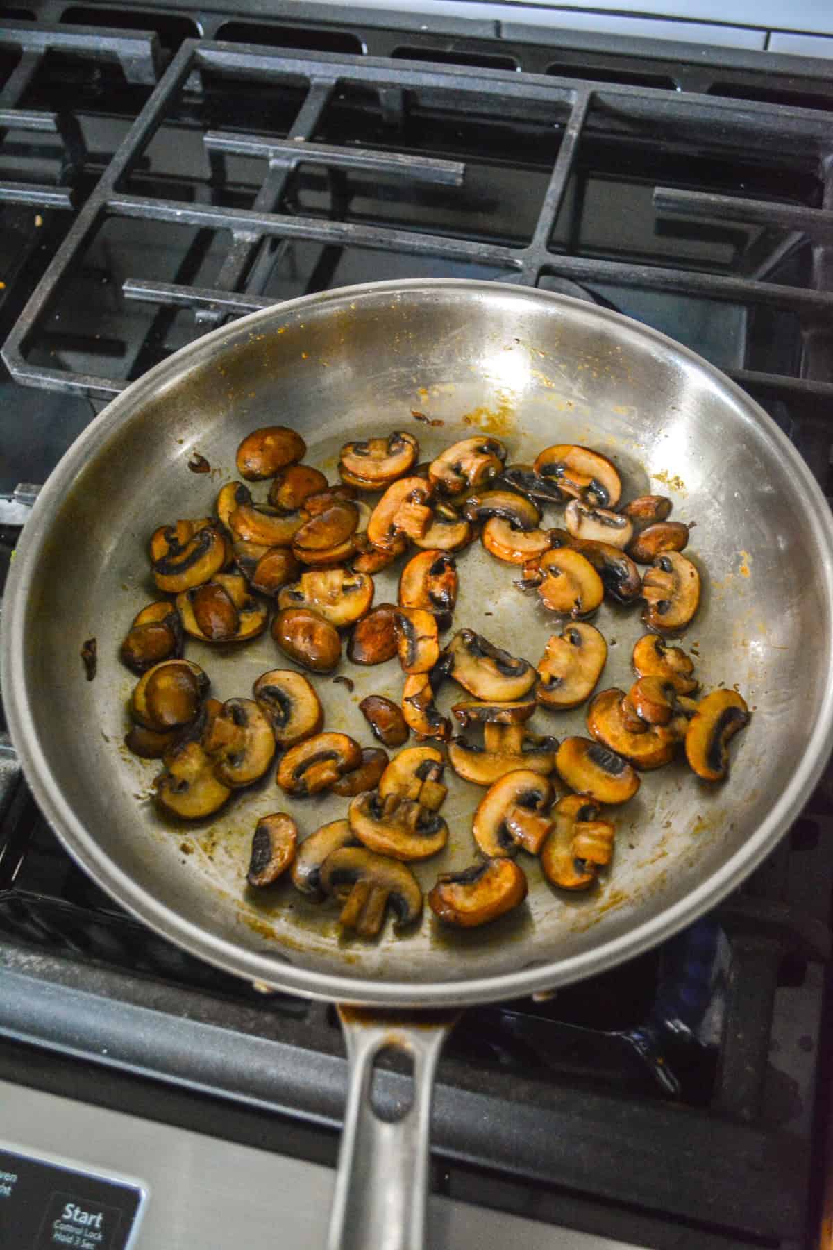 Sautéed mushrooms in a skillet. 