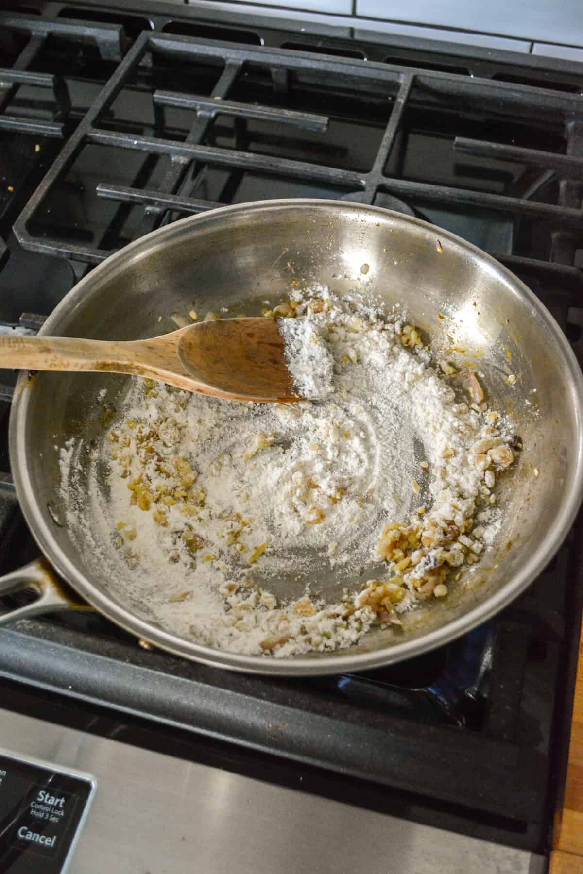 Flour added into a skillet.