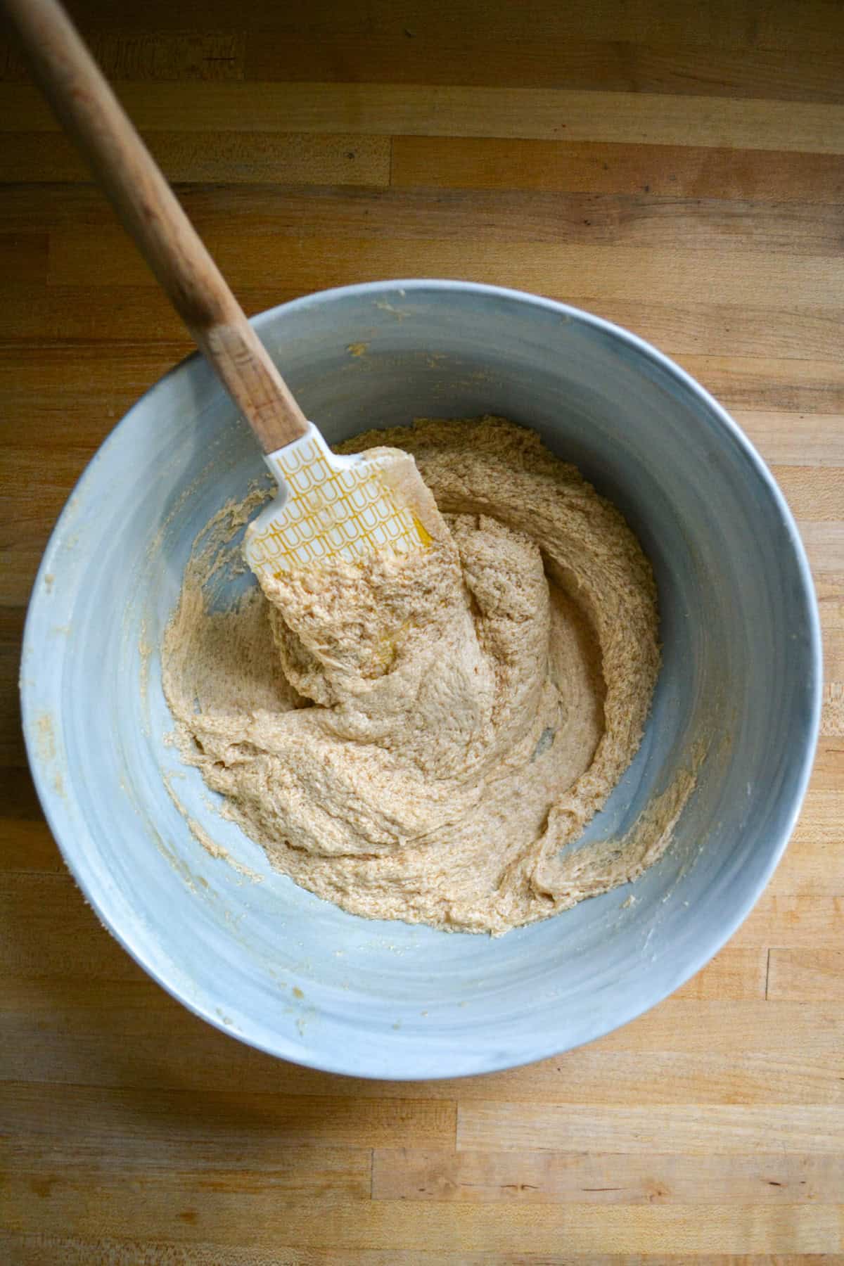 Non-dairy milk and vanilla added to the mixture in the large bowl.
