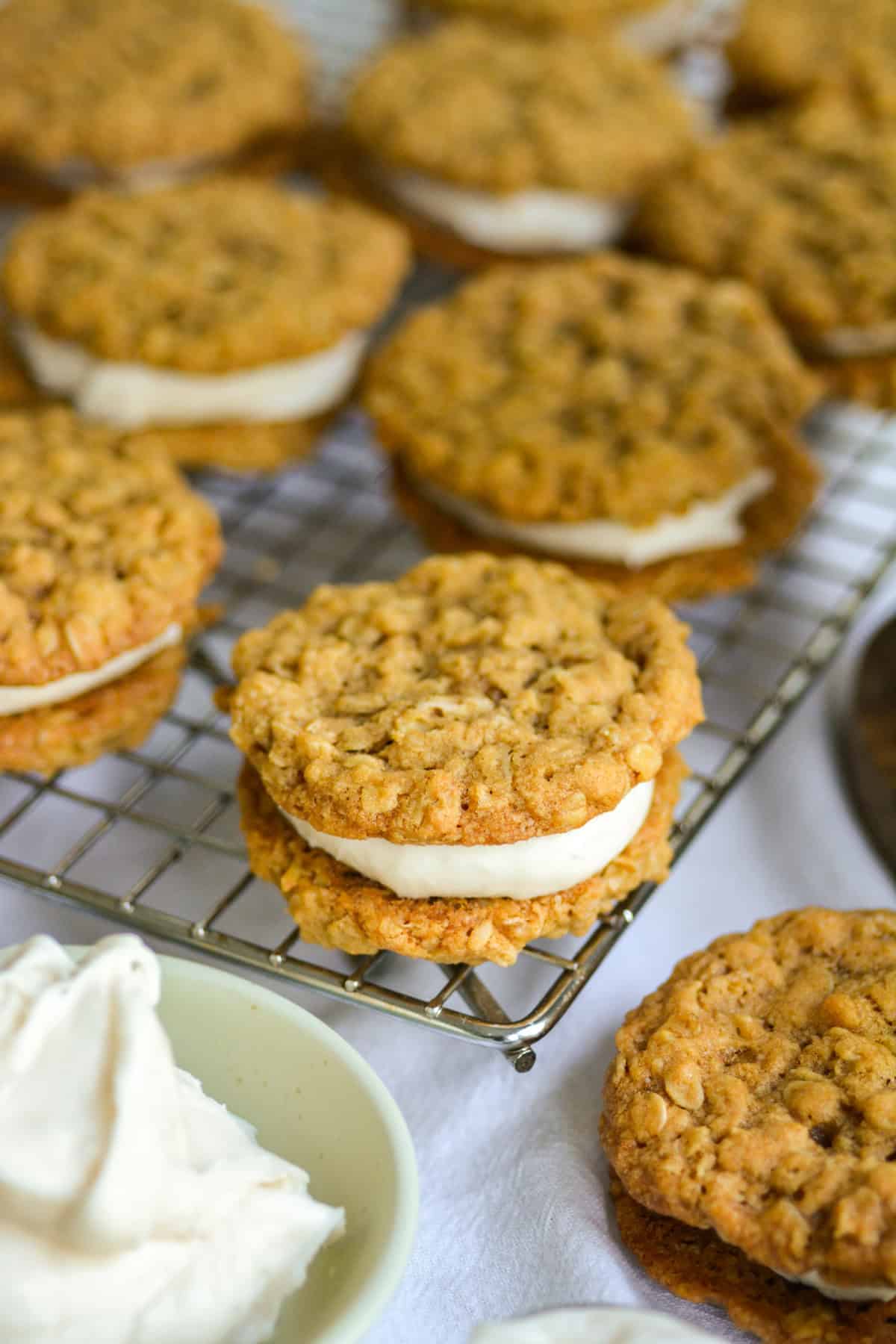 Homemade Vegan Oatmeal Cream Pies on a wire cooling rack.