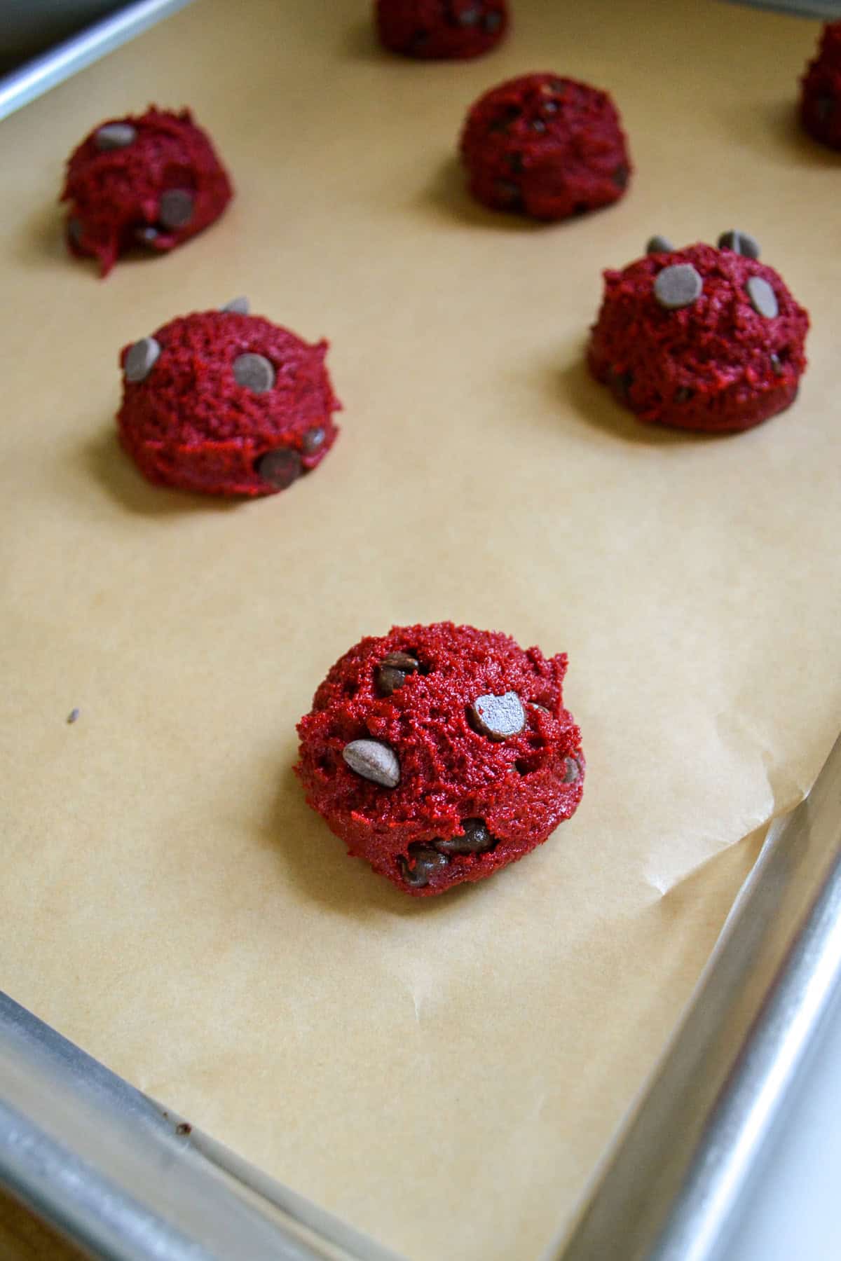 Cookies scooped onto a parchment-lined baking sheet.