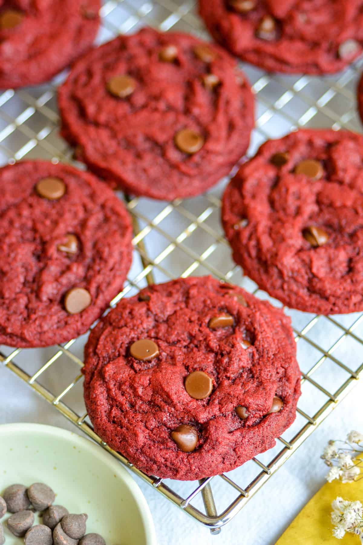 Vegan Red Velvet Chocolate Chip Cookies on a wire cooking rack.