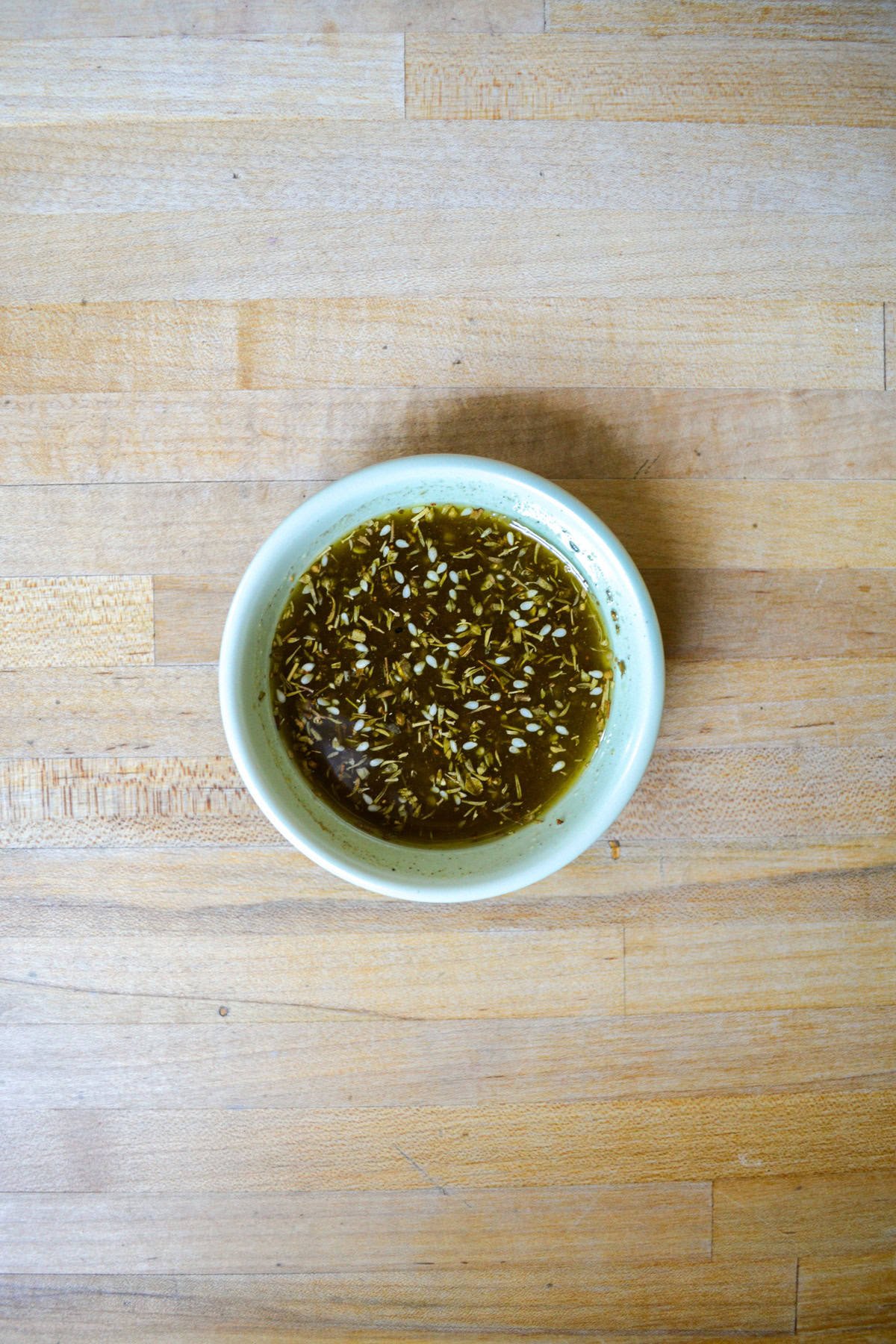 Olive oil and spices mixed together in a small bowl.