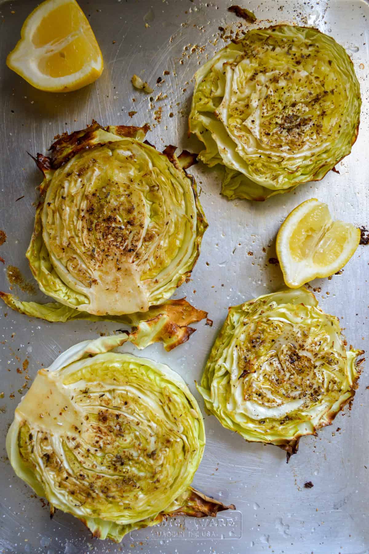 Cabbage steaks on a baking sheet after roasting.