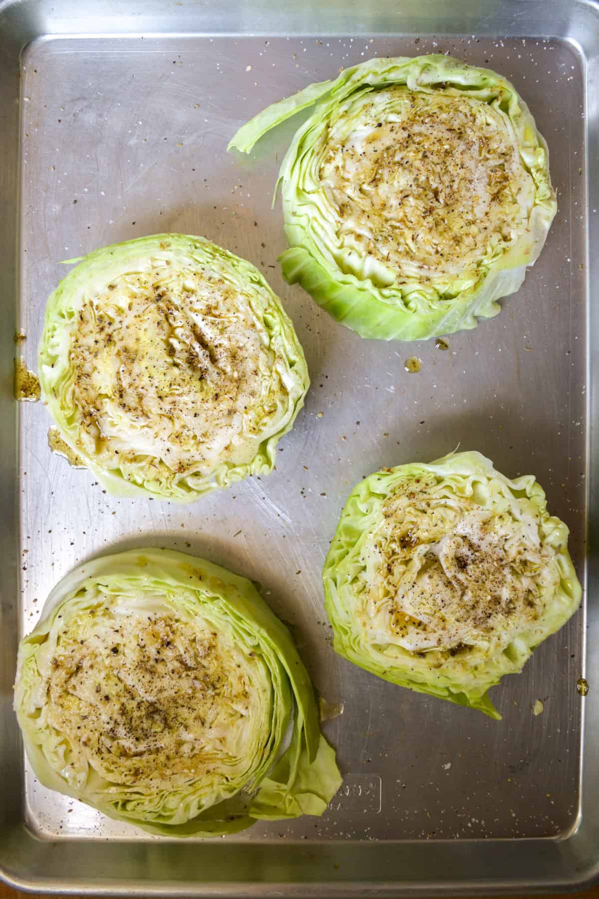 Seasoned cabbage on a baking sheet.