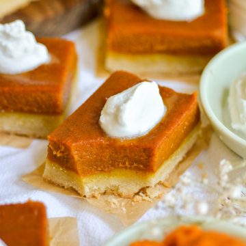 Vegan Pumpkin Pie Bar on a linen cloth with a bite taken out of it.
