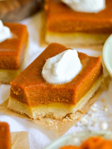 Vegan Pumpkin Pie Bar on a linen cloth with a bite taken out of it.