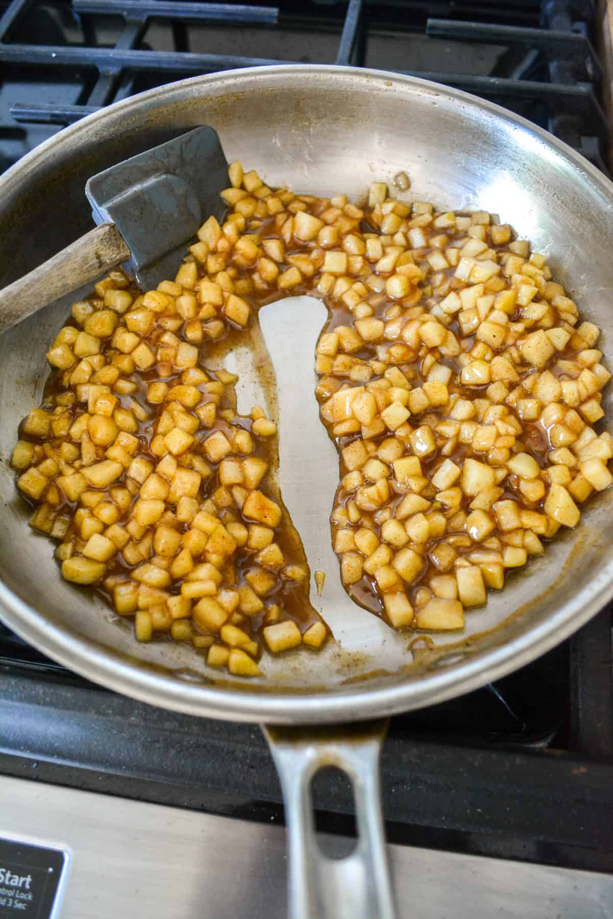 Apple pie filling in a stainless steel skillet.