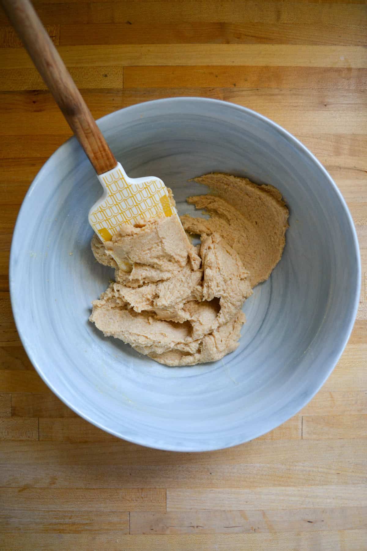 Non-dairy butter and brown sugar creamed together in a large mixing bowl.
