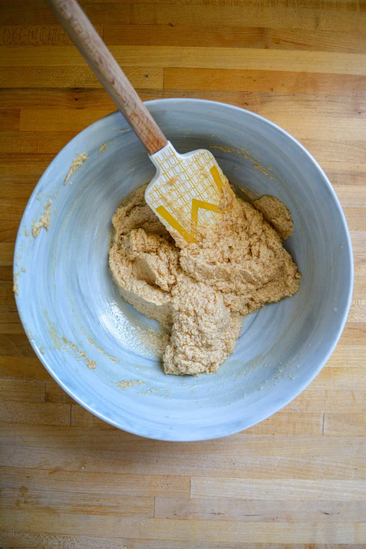 Non-dairy milk and vanilla added into the bowl with butter and brown sugar.