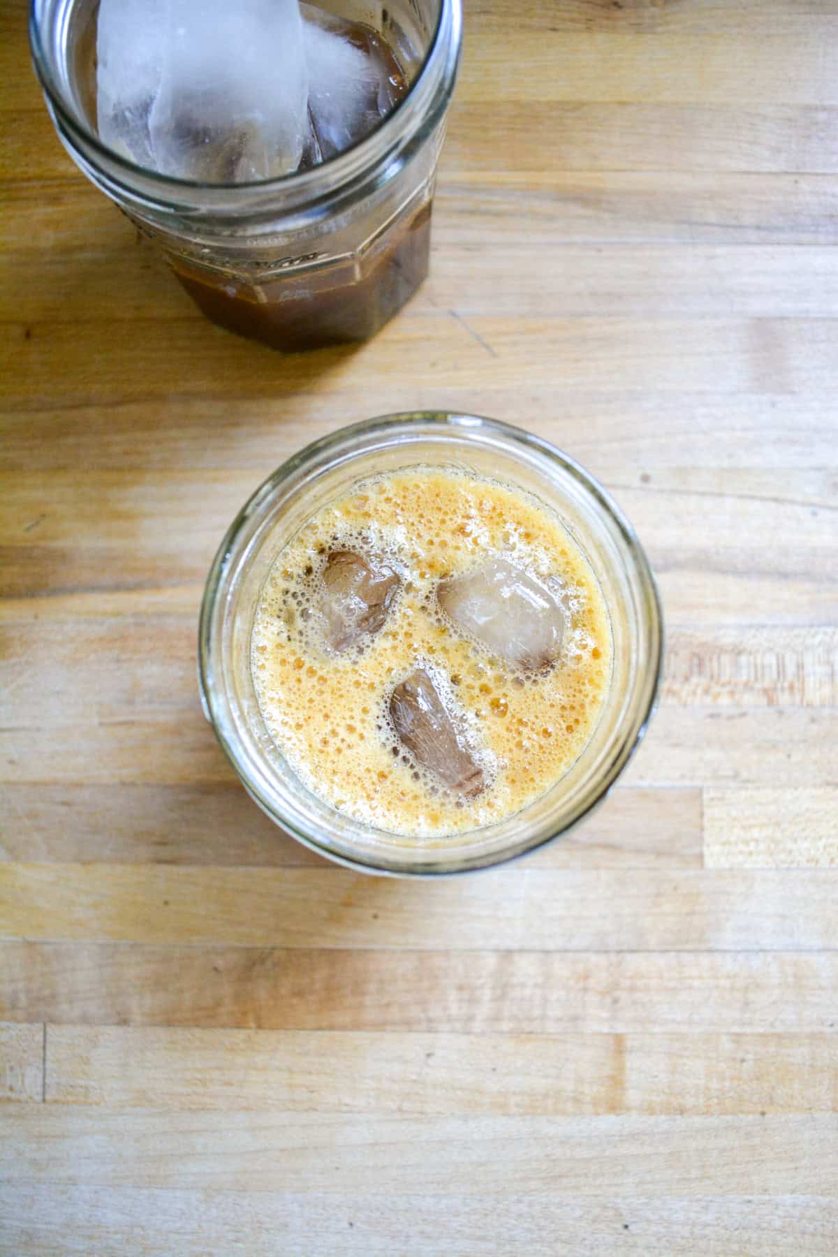 Espresso shaken with brown sugar syrup and cinnamon in a small glass.