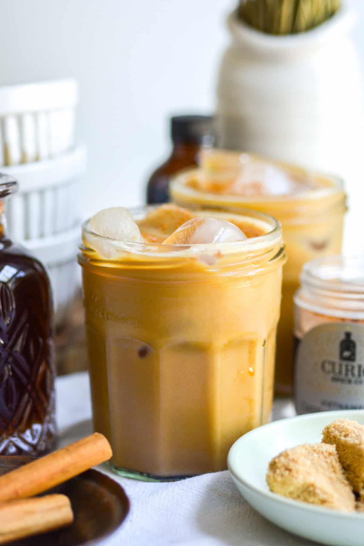 A glass of Iced Brown Sugar Latte on a linen cloth.