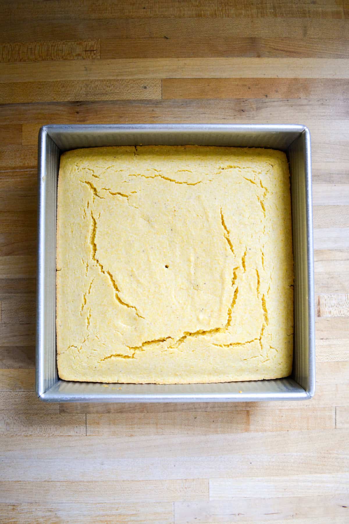 Baked cornbread in a square baking pan.