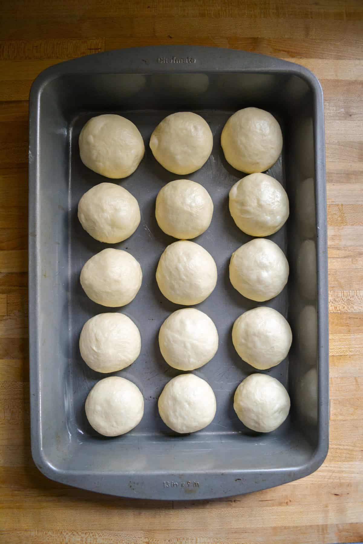 Dough balls placed into a pan.