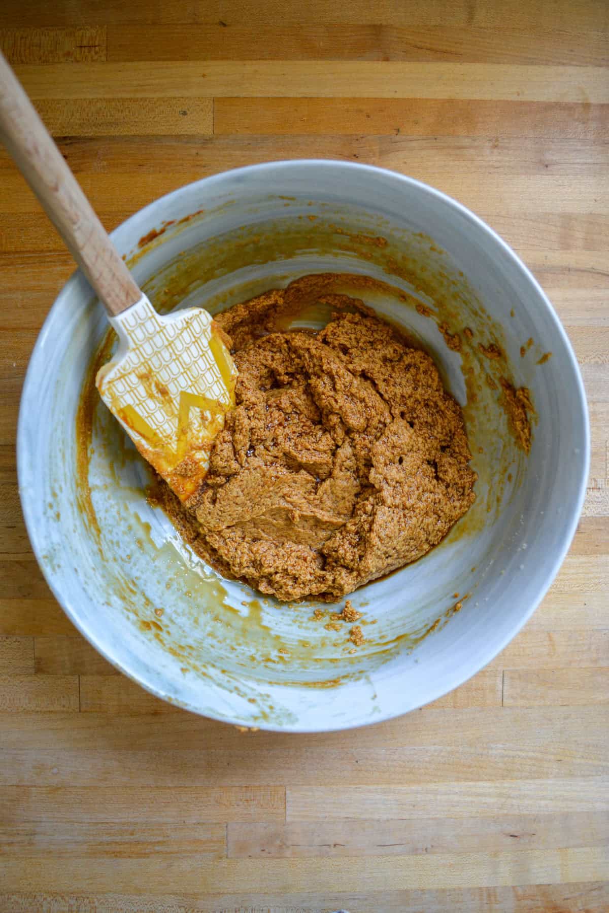 Non-dairy milk and vanilla added into the mixing bowl.