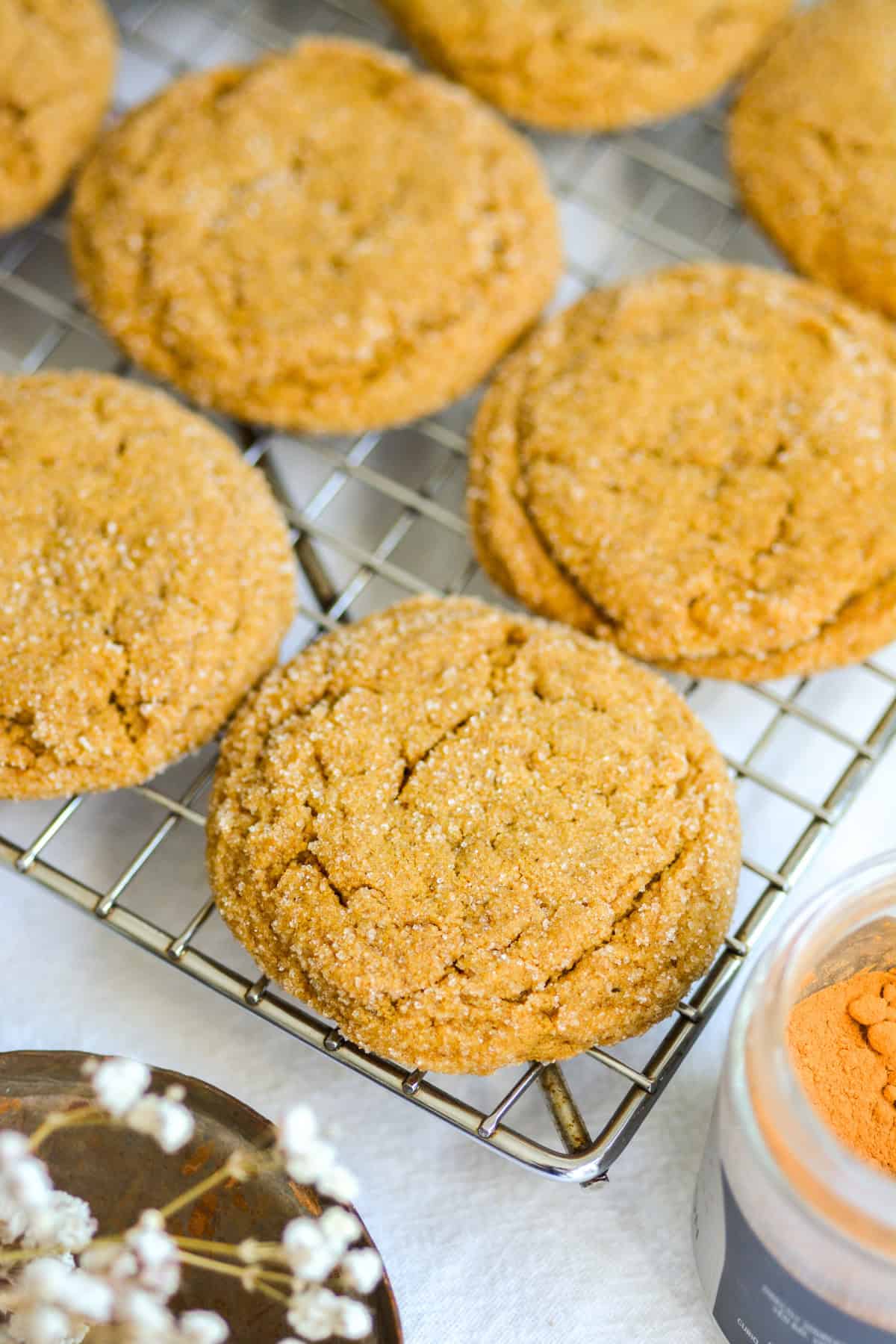 Chewy Vegan Molasses Ginger Cookies on a wire cooling rack.