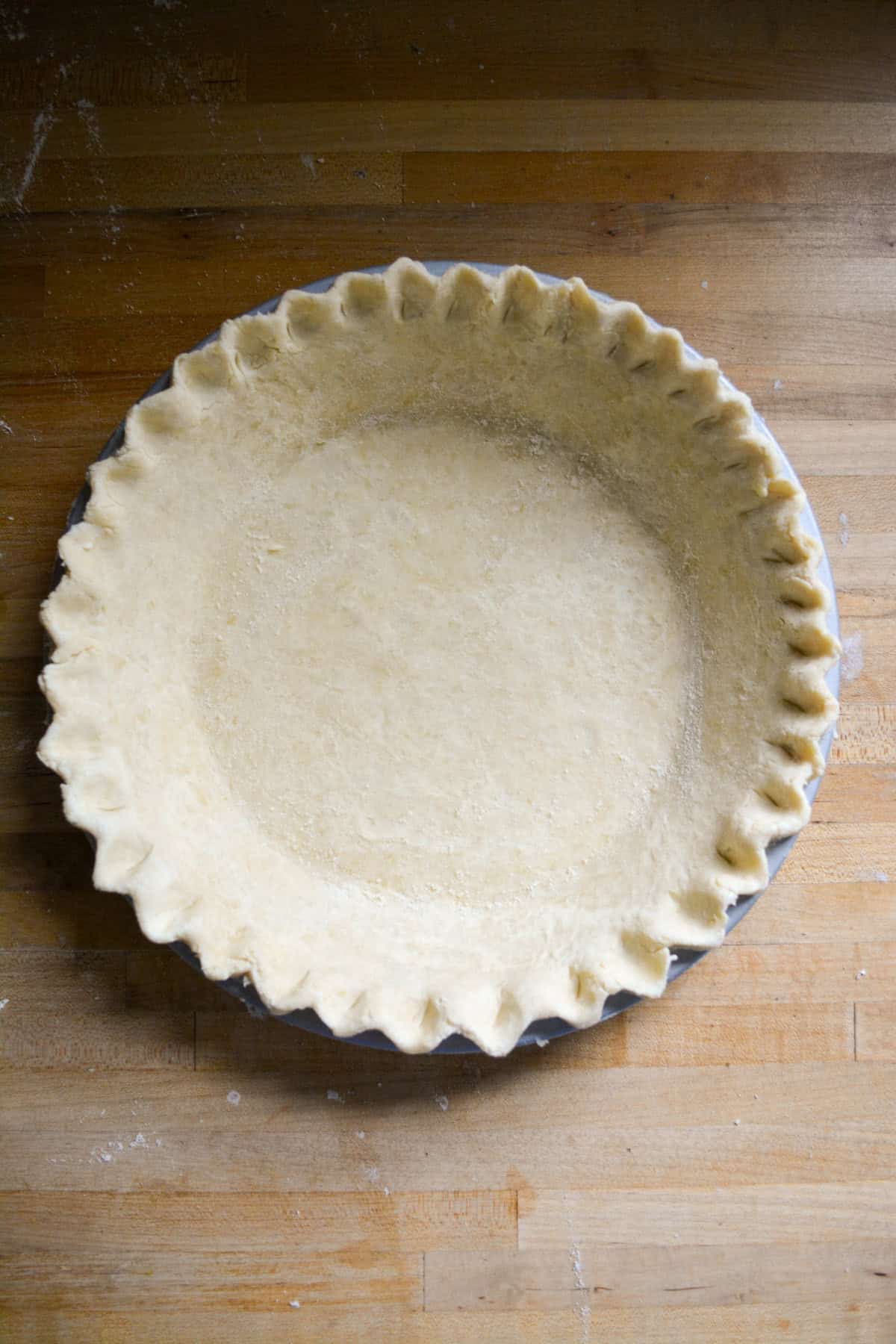 Pie dough in a pie plate.