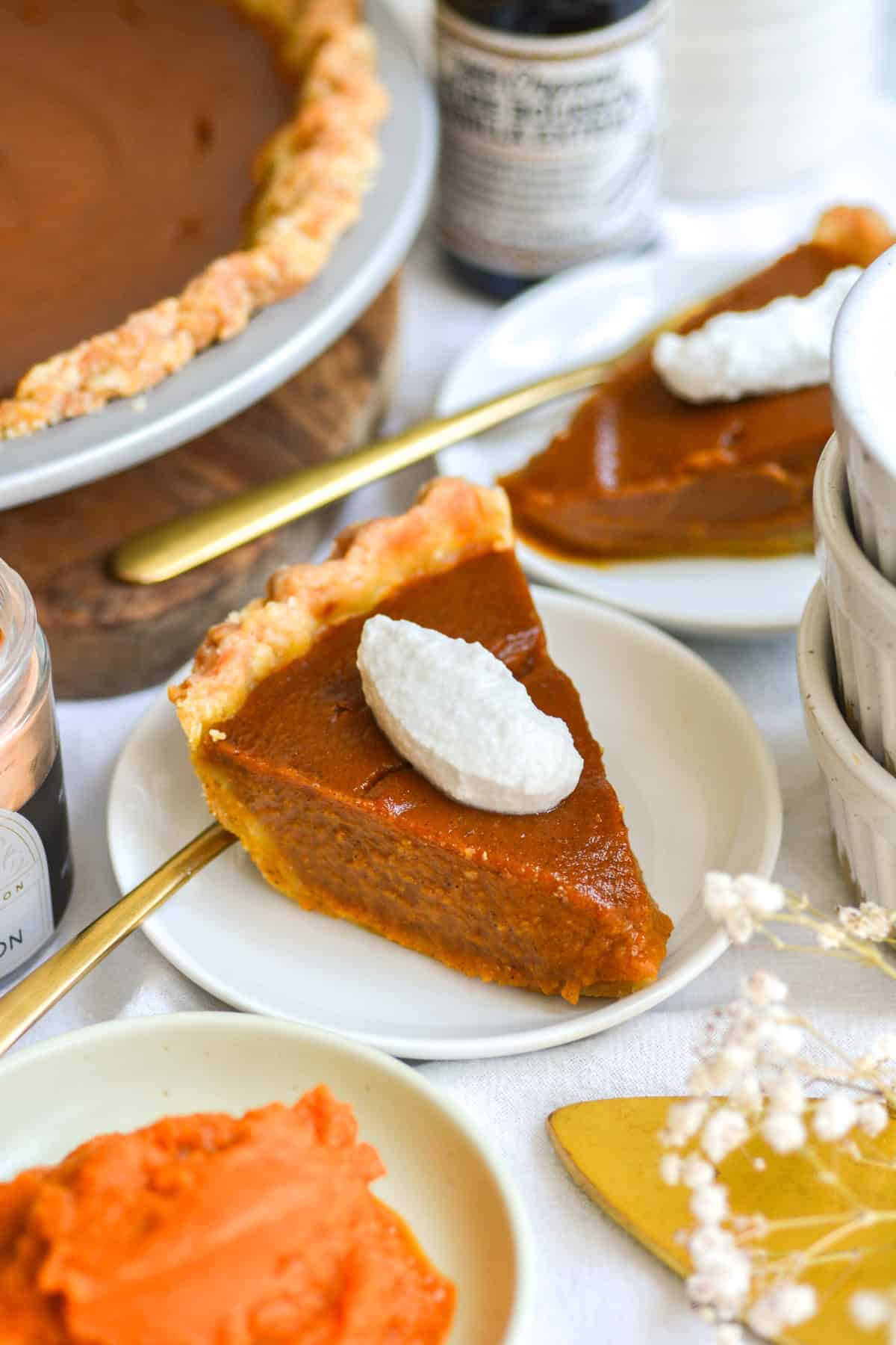 A slice of Vegan Pumpkin Pie on a small white plate.