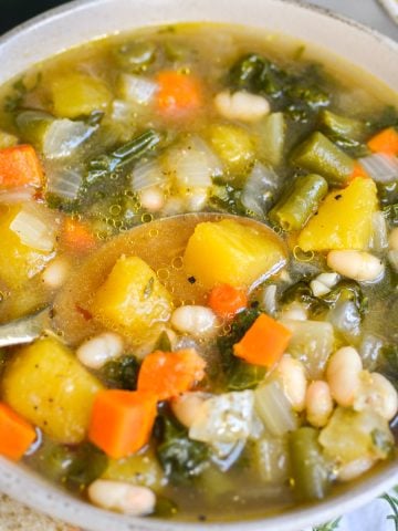 Acorn Squash Soup with White Beans in a bowl.