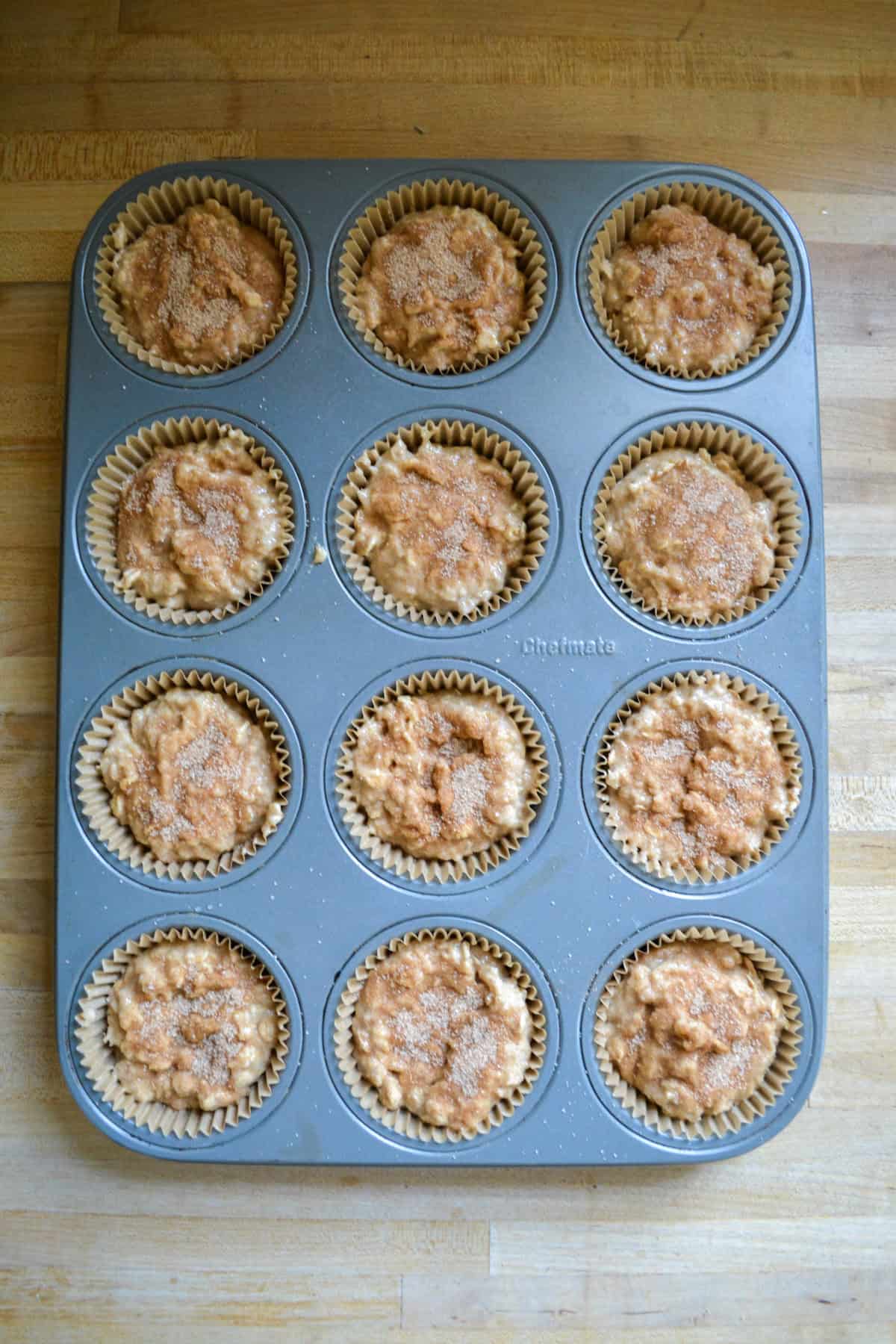 Batter scooped into a lined muffin tin.